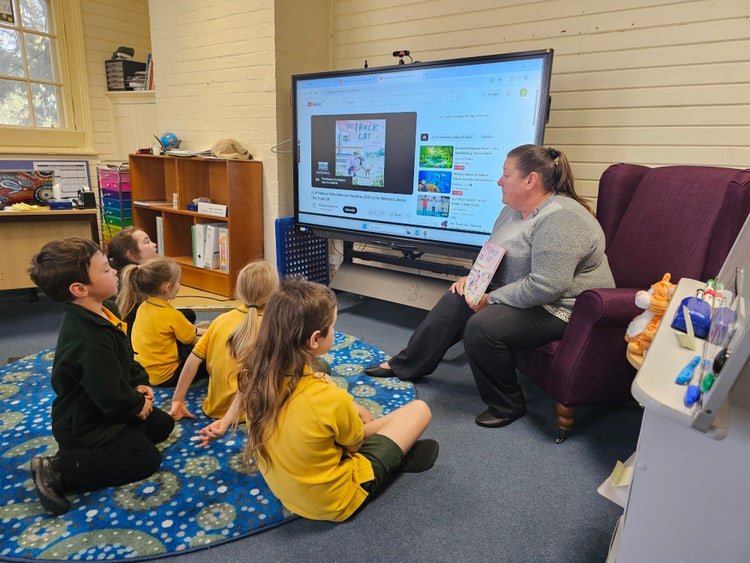 showing students engaged in learning and discussions with the classroom teacher